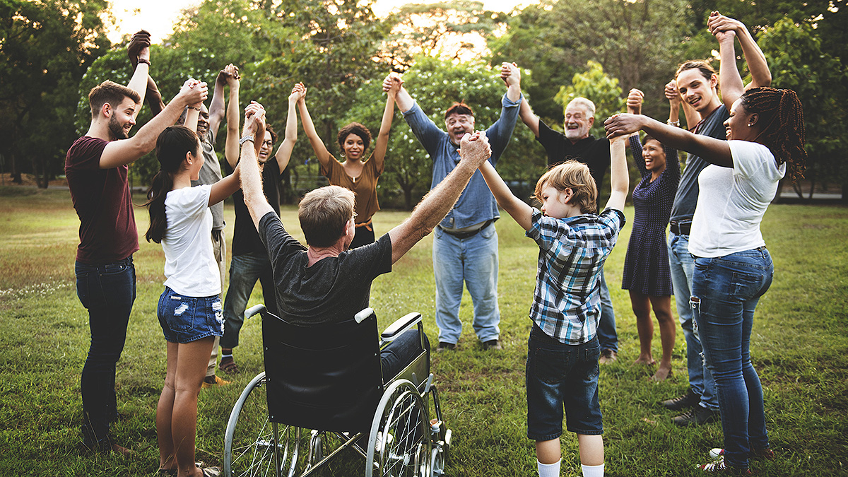 Group of people holding hand together in the park